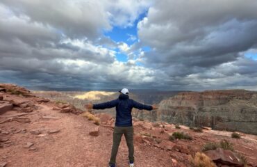 Photo of a man looking over the Grand Canyon