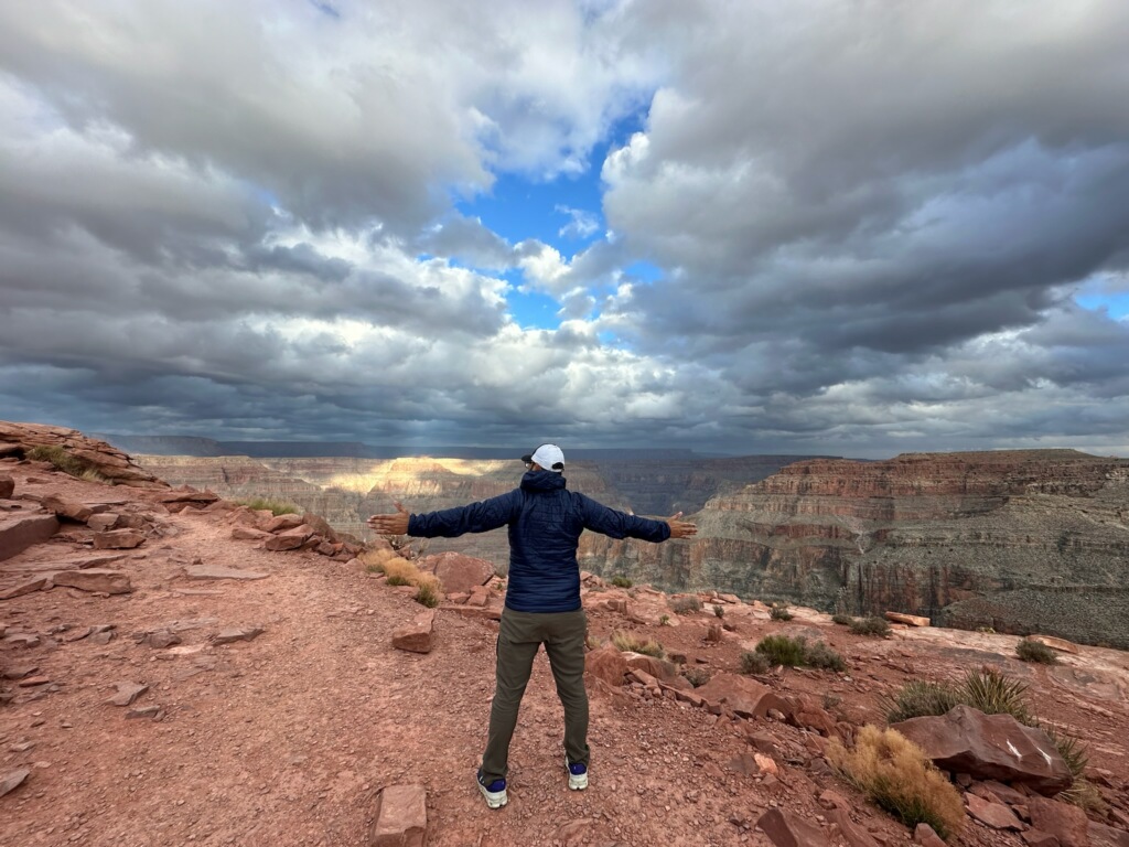 Photo of a man looking over the Grand Canyon