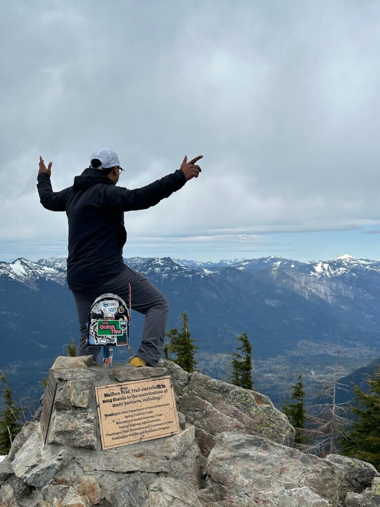 Photo of Sujit at the summit of Mailbox Peak in Washington State. 